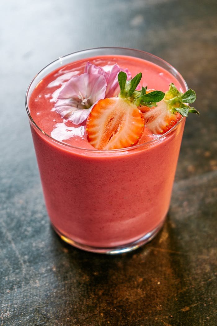 Smoothie Decorated with Strawberry Slices and Flowers
